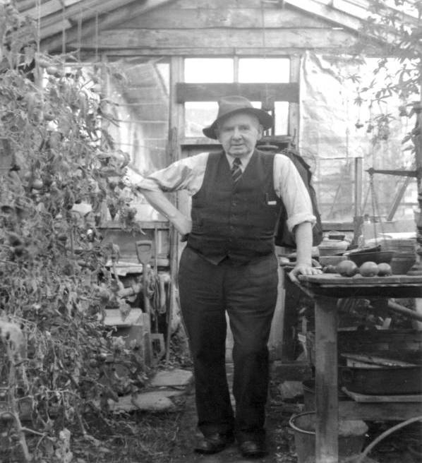 Photo of John Crombie Rae outside his greenhouse