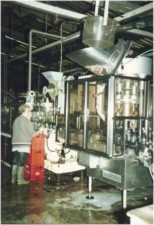 Photo of Nancy Blench keeping watch on Bottle Capping Machine