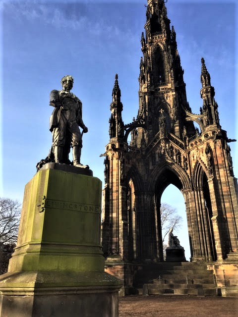 Statue of David Livingstone in Princes Street, Gardens, Edinburgh, by Amelia Hill, with the massive Scott Monument as a backdrop. Photographed by Cat Berry at The Amelia Trail