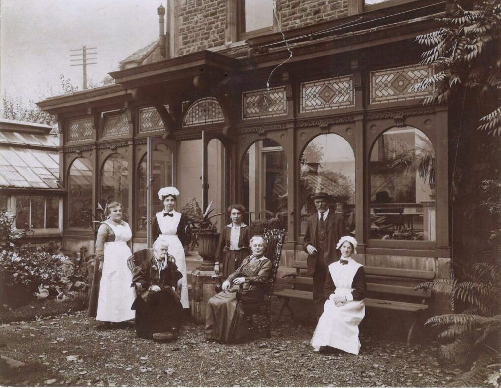 Photo of Jane, seated centre, with her servants outside her Cardiff house