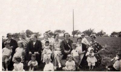Photo of a group of women and children at a Lassodie picnic/gala, including Peggy's mother with Peggy, aged around two years, on her knee