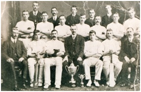 Photo of the Elgin Rubberwork’s Cricket Team c.1925 with factory manager, Sandy Howie 3rd from left in the front row with members of the Stewart family in suits in front row